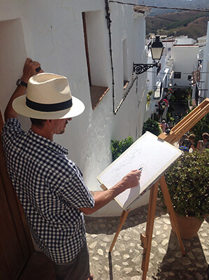 Photo of the interior of the art studio with watercolours, books and calendar