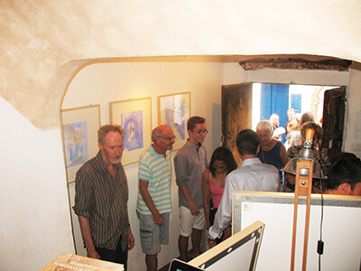 Photo of people visiting the art exhibition in Frigiliana of original watercolour paintings by Klaus Hinkel
